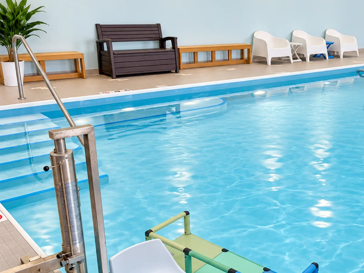 The pool lift, entry steps and seating along the wall of the warm-water pool at Anchor Wellness Studio